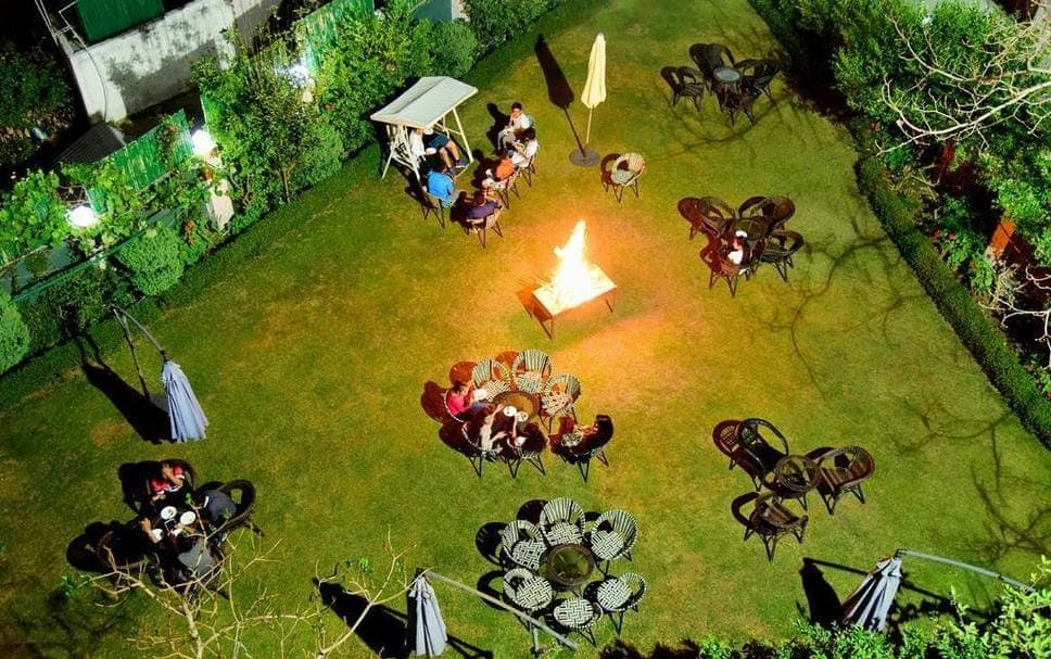 Garden event setup with outdoor tables and a bonfire at The Royal Court