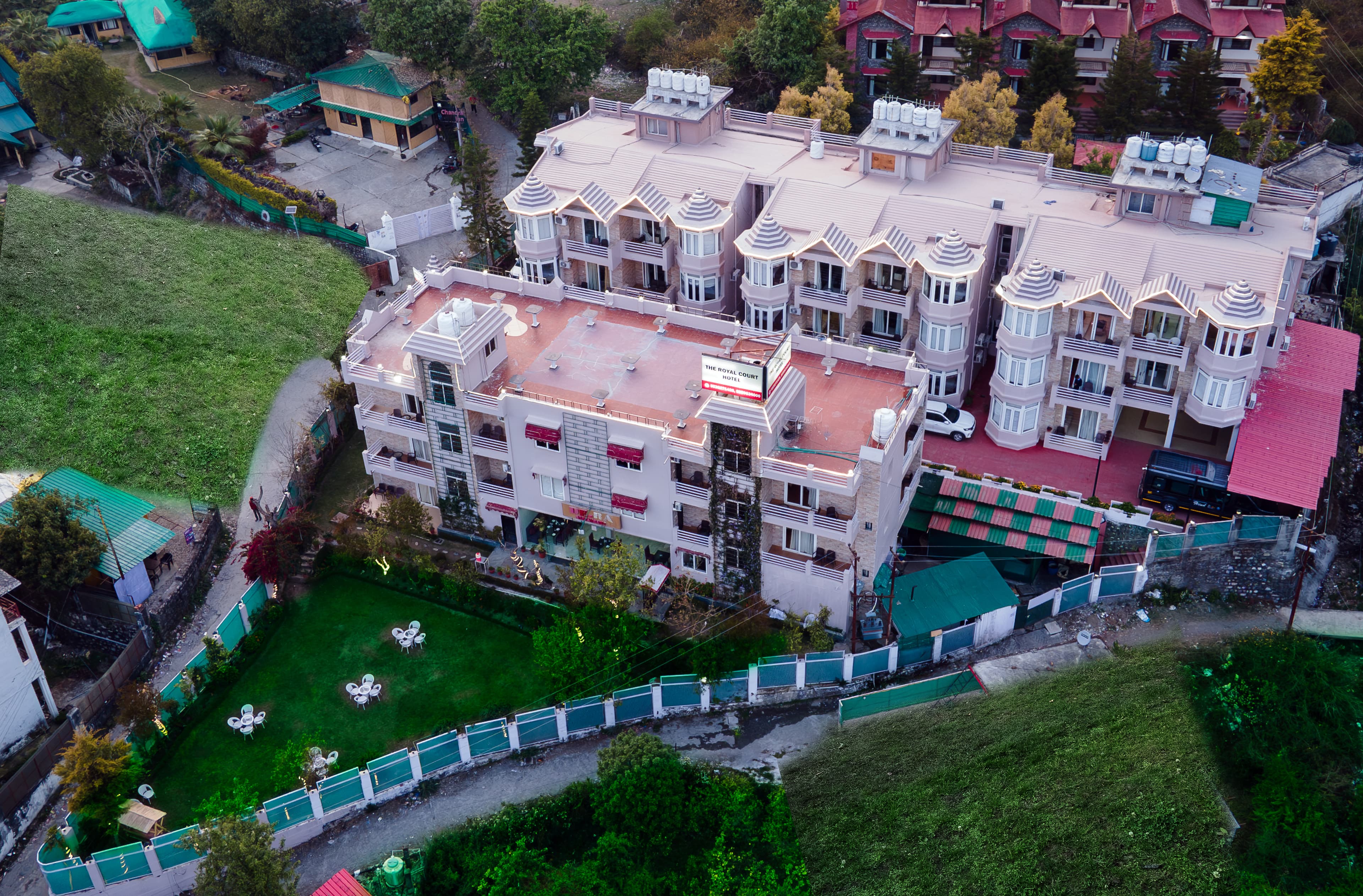 Aerial view of The Royal Court hotel and its landscaped lawn in Bhimtal